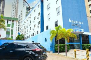 a black suv parked in front of a building at Hotel Aquarius in Fortaleza