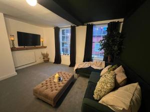 a living room with a couch and a tv at Friar Loft in Worcester