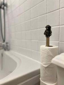 a roll of toilet paper with a statue on top of it at Friar Loft in Worcester
