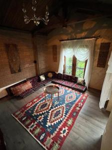 a living room with a rug on the floor at Bursa Iznik (Nicea) Doğa İçinde Eşsiz Çiftlik Evi in İznik