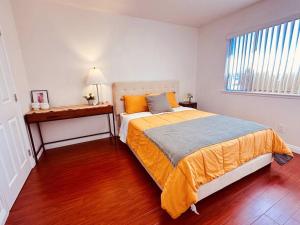 a bedroom with a large bed and a window at Charming 3BR Retreat near Disneyland Downtown LA! in Rowland Heights +22 photos