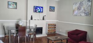 a living room with a dining table and a fireplace at HOME AWAY FROM HOME in Cape Town