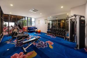 a fitness room with a gym with exercise equipment at Comfy King The Straits Suite 715 by Elefen Homestay in Melaka