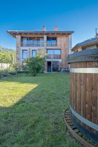 a house with a large yard in front of it at Chalet l'ozio creativo in Castelnuovo Nigra