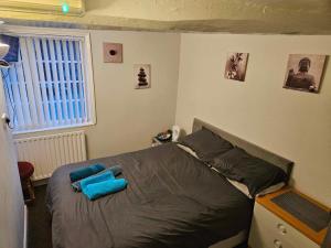 a bedroom with a bed with blue pillows on it at The White Lion Inn in Brinklow