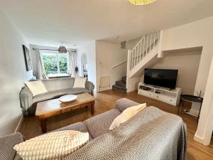 a living room with a couch and a tv at 3 Bedroom House 2 stops from London Bridge in London