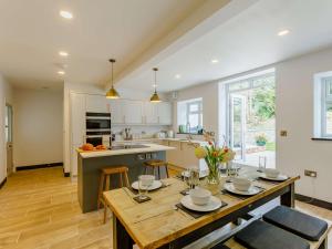 a kitchen and dining room with a table and chairs at 4 Bed in Chulmleigh 85596 in Chulmleigh