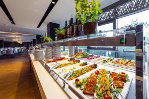 a buffet line with salads and appetizers at Hotel Helikon, Keszthely in Keszthely