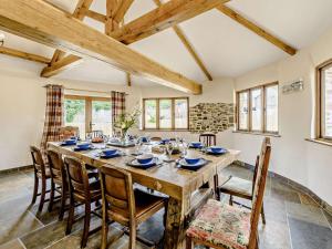 a dining room with a large wooden table and chairs at 6 Bed in Great Torrington 81519 in Great Torrington