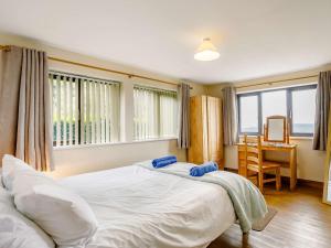 a bedroom with a large white bed and a desk at 3 Bed in Todmorden 82953 in Todmorden