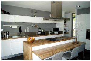 a kitchen with a wooden counter top in a room at Maison vue panoramique in Saint-Pierre-Aigle