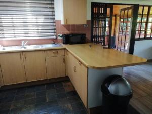 a kitchen with a counter and a sink and a counter sidx sidx at Traveller's dream in Graskop +21 photos