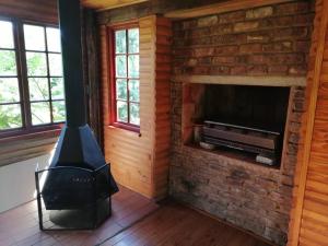 a brick fireplace with a stove in a room at Traveller's dream in Graskop