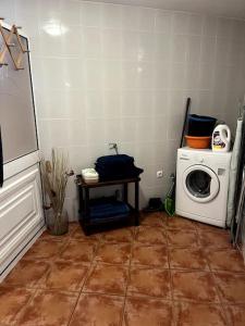 a laundry room with a washing machine and a washer at Kleines Haus am Meer in Arco da Calheta