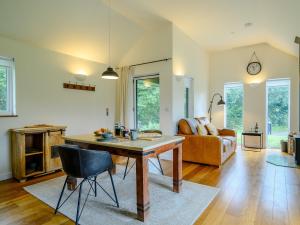 a living room with a table and a couch at 1 Bed in Talybont-on-Usk 88138 in Talybont