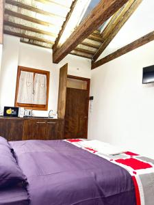 a bedroom with a bed and a wooden ceiling at Venice Rainbow apartments San Zaccaria in Venice
