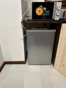 a microwave sitting on top of a refrigerator at Venice Rainbow apartments San Zaccaria in Venice