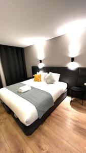 een slaapkamer met een groot bed met witte lakens en kussens bij Apartamento Sociedade Farmaceutica in Lissabon