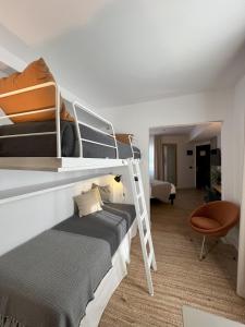 a room with two bunk beds and a chair at Hotel San Miguel Menorca in Mahón
