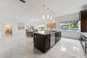 an open kitchen and dining room with a dining table at Miami Puzzle Lake Escape, Games, Pool, BBQ, Views L58 in Miami