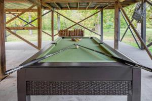 a pool table sitting inside of a pavilion at Riverfront Cabin wFirepit Pool Table Porch WiFi in Hedgesville