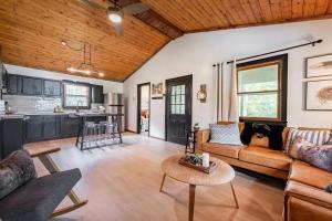 a living room with a couch and a table at Riverfront Cabin wFirepit Pool Table Porch WiFi in Hedgesville