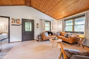 a living room with a couch and a table at Riverfront Cabin wFirepit Pool Table Porch WiFi in Hedgesville