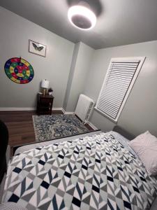 a bedroom with a black and white bed and a window at Cozy on the Hill in Wilmington