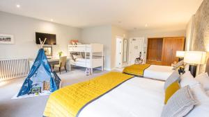 a bedroom with two beds and a desk and a bed at Mulranny Park Hotel in Mulranny