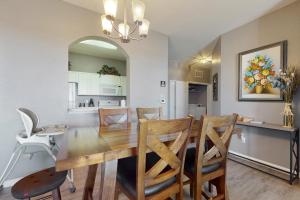 a dining room and kitchen with a wooden table and chairs at Family Fiesta in Orlando