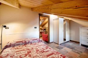 a bedroom with a bed and a wooden ceiling at Appartamento Aquila in La Salle