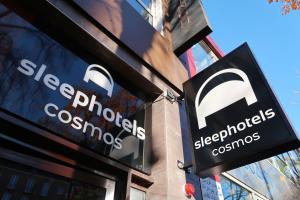a store sign on the side of a building at Sleephotels Cosmos in Hamburg