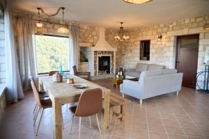 a living room with a table and a couch at Villa Agia Sofia ένα υπέροχο καταφύγιο στο βουνό in Ayía Sofía