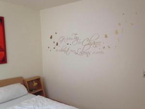 a bedroom with a bed with a sign on the wall at Ferienhaus Gut Düneburg in Haren