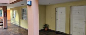a hallway with two white doors in a house at Nuestra Recova en Pilar BsAs in Pilar +34 photos