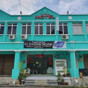 a blue building with a sign for a motel at Dimensi Hotel in Kampong Alor Gajah