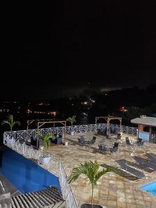 a view of a swimming pool at night at Pousada Ponta do Leste in Angra dos Reis