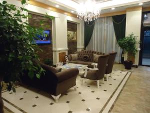 a living room with couches and a table at MOONLİGHT HOTEL in Bostaniçi