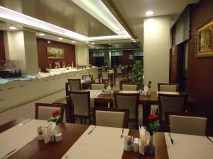 a restaurant with tables and chairs and a counter at MOONLİGHT HOTEL in Bostaniçi