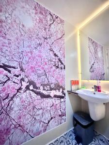 a bathroom with a pink wallpaper and a sink at Doms Ryokan in Avida Aspira With Wifi and Netflix in Cagayan de Oro