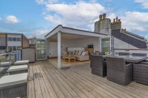 a rooftop deck with a living room and a couch at Upper Anzac in Brixham