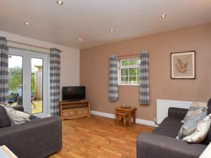 a living room with two couches and a television at 1 bed in Burnham-on-Sea ALPAD in Highbridge