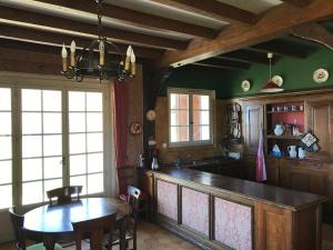 a kitchen with a table and a dining room at Grande maison familiale dans le massif des Bauges in Montcel