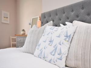 a bed with white sheets and a gray headboard at 2 Bed in Appledore DECKH in Appledore