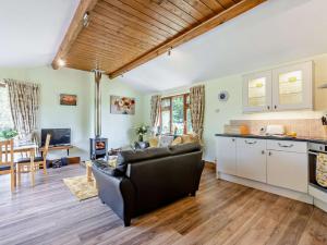 a living room with a couch and a kitchen at 1 Bed in South Molton OAKVI in South Molton