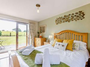 a bedroom with a large white bed and a balcony at 1 Bed in South Molton OAKVI in South Molton