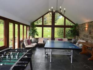 a living room with a ping pong table in it at 5 Bed in Bampton GRACI in Oakford