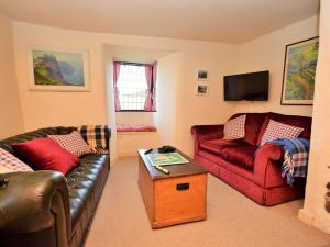 a living room with two couches and a tv at 3 Bed in Bude PORTH in Morwenstow