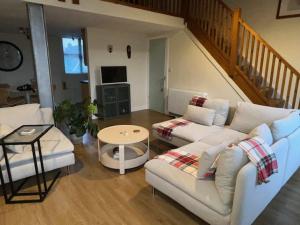 a living room with a couch and a table at Silk Mill Apartment in Macclesfield