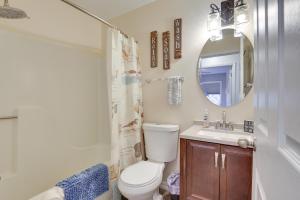 a bathroom with a toilet and a sink and a mirror at Walkable Lead Condo 5 Mi to Terry Peak Ski Area! in Lead +19 photos